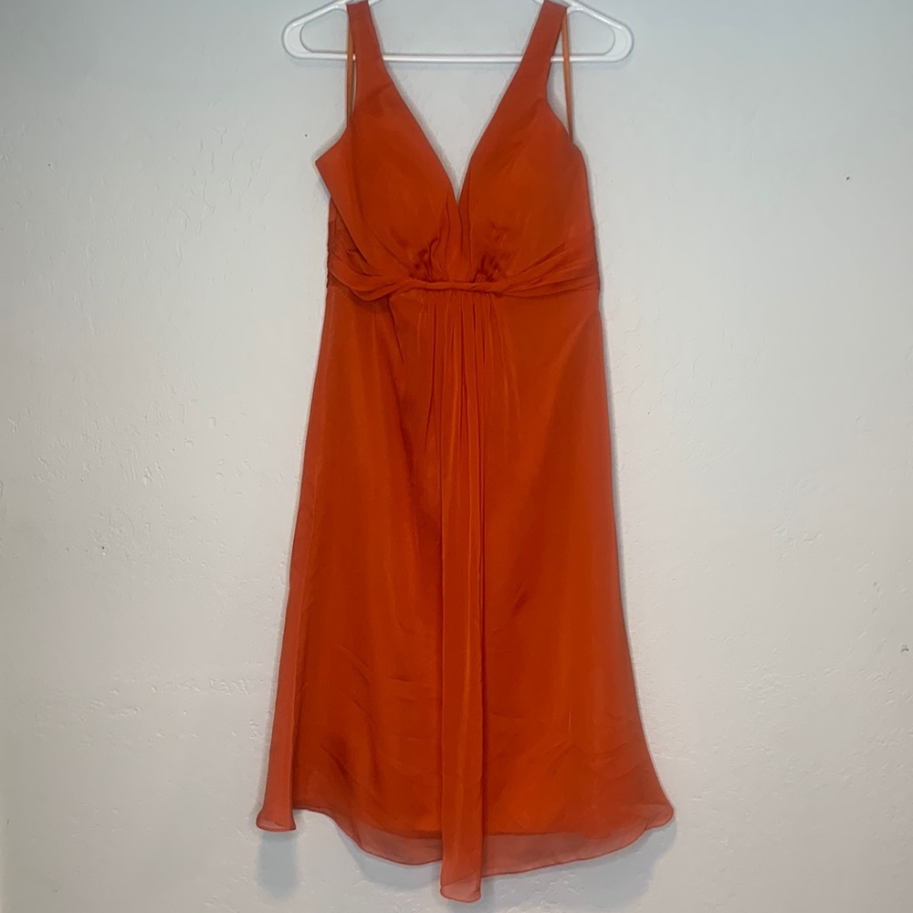 Womens size 10 Orange mid length formal dress never worn.